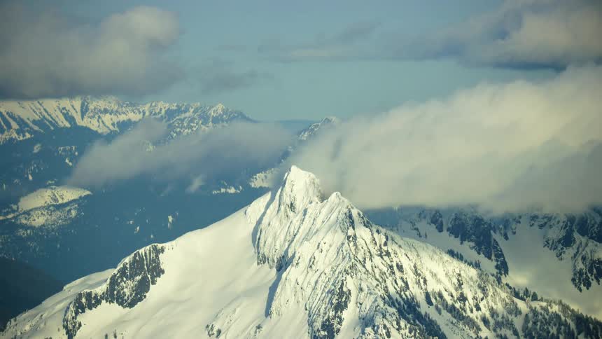 The North Cascade mountains are covered in thick mountain snow in this high altitude aerial from 10,000 feet