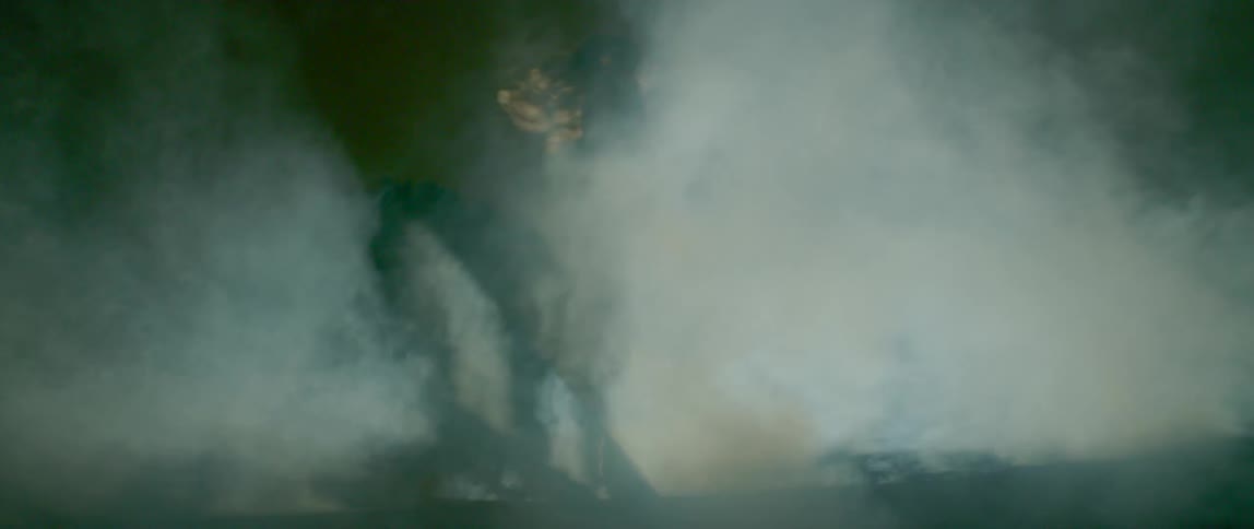 Woman dances while in a cloud of smoke