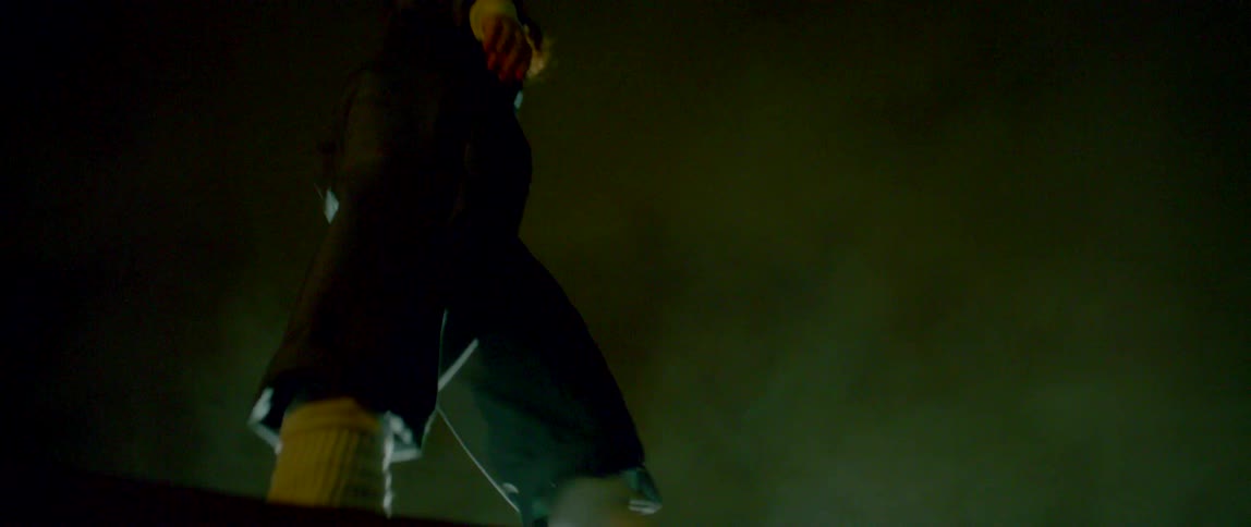A person dancing on a ledge with smoke
