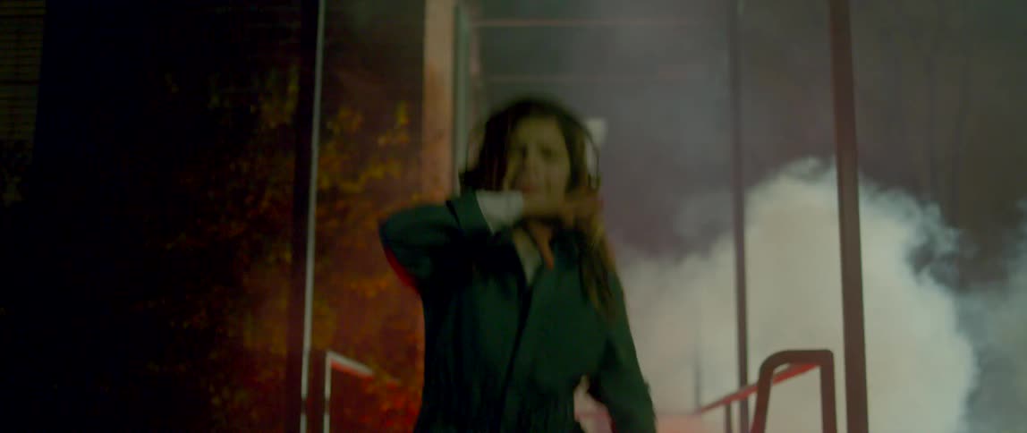 A woman dancing outdoors at night