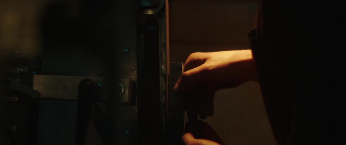 A man takes apartment equipment in a dark lab