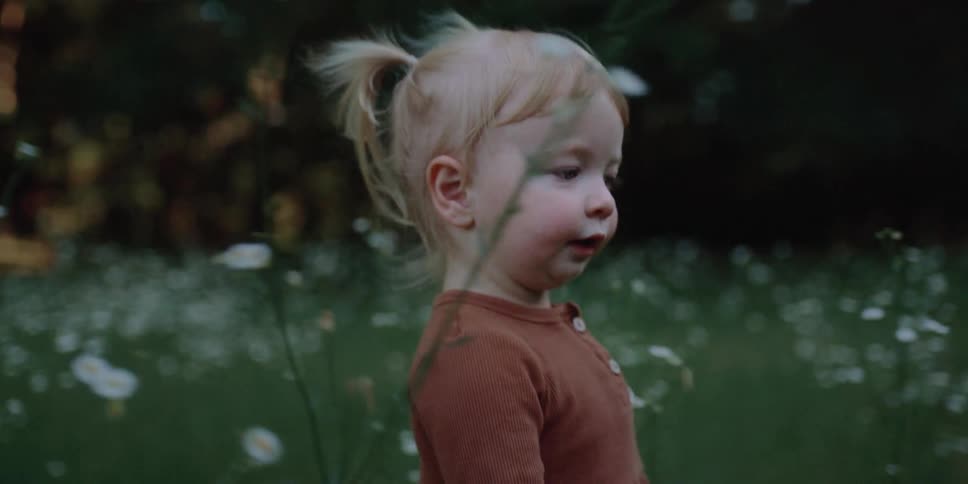 Child walking in flowers