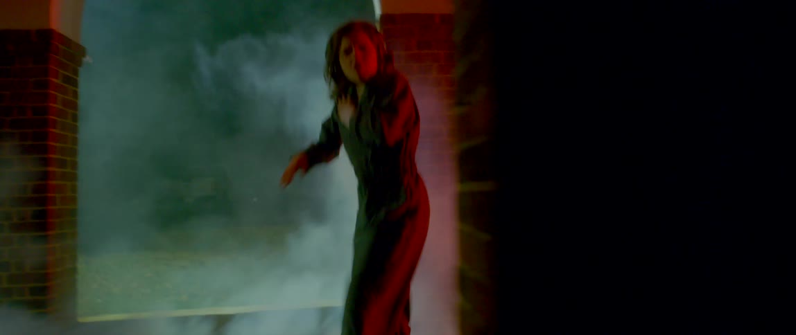 A teenage girls dances outside in fog