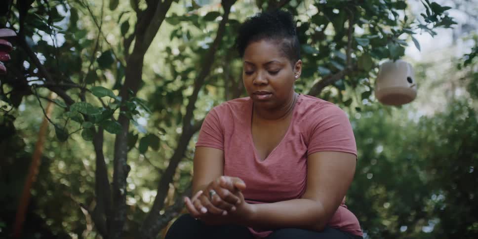 A woman is praying outside