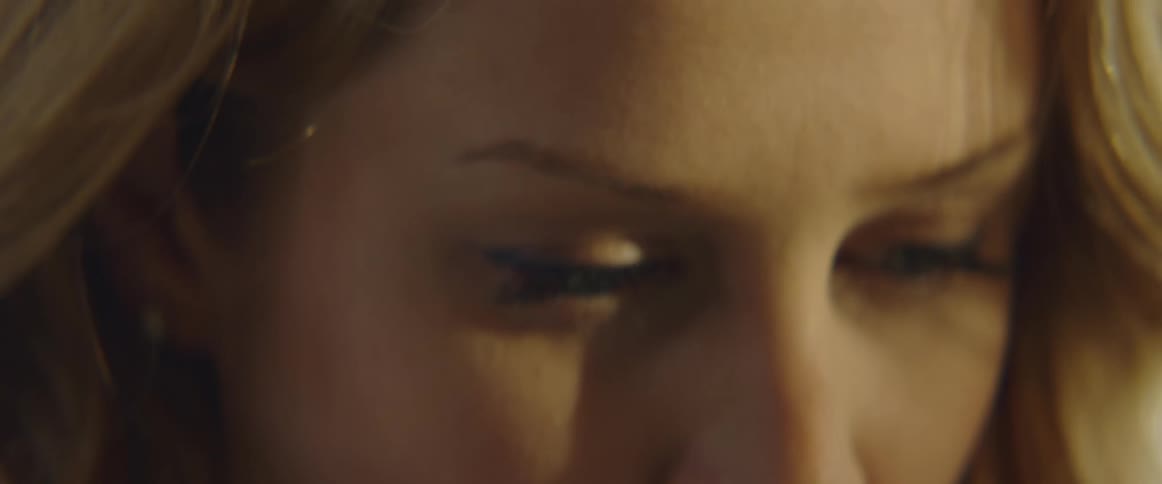 A woman in a room with a nose ring