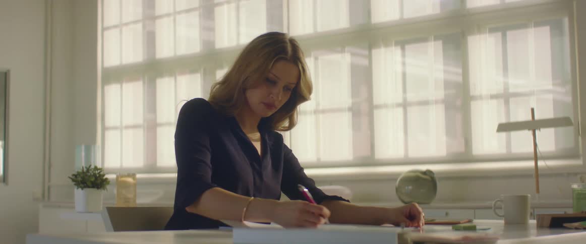 Woman drawing at desk