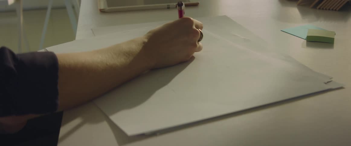 A person drawing on a piece of paper