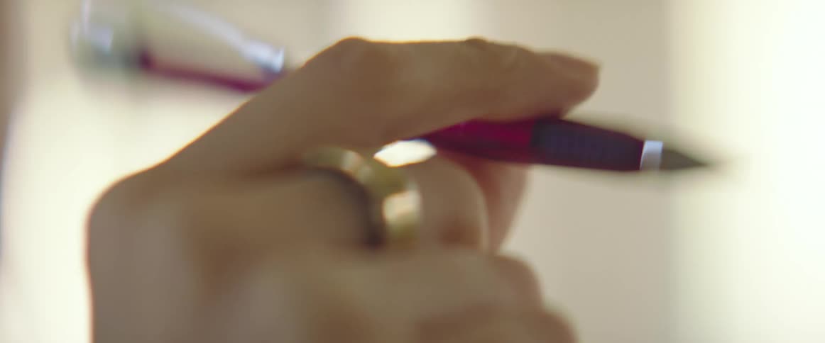 A woman flicking a led pencil around in her hand