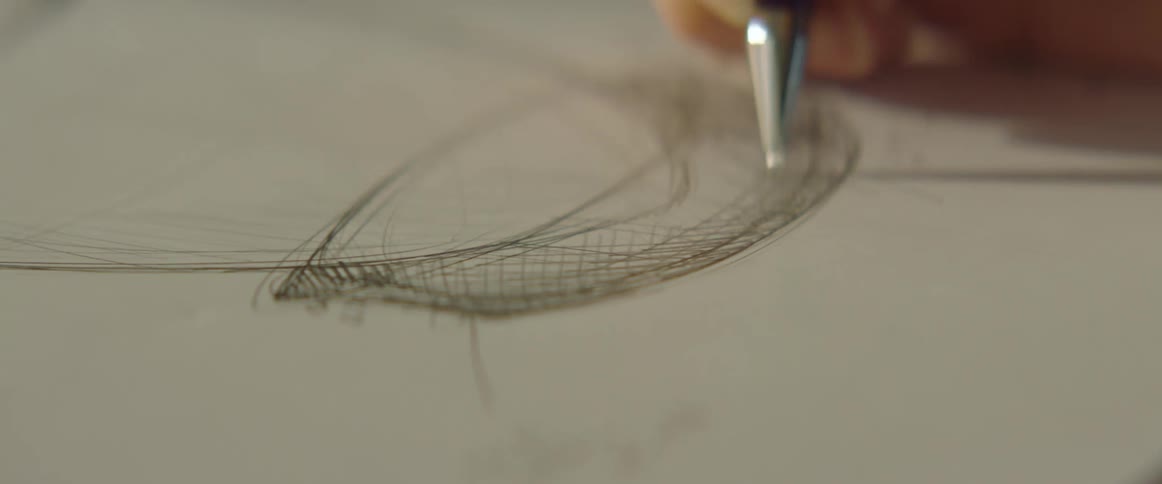 A person drawing a cup using a mechanical pencil