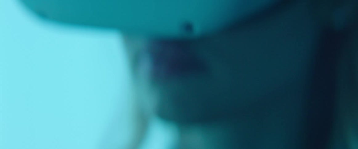 A woman in a room with a virtual reality headset on with a wall in the background