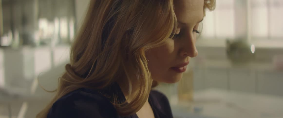 A woman is at home looking at something
