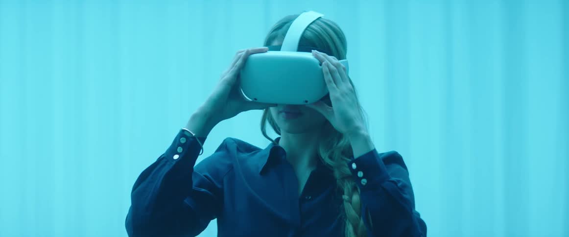 A woman puts on a virtual reality headset
