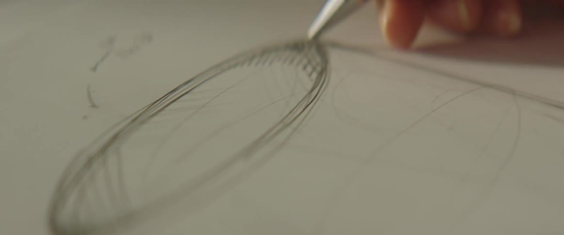 Womans hand makes a drawing with a mechanical pencil