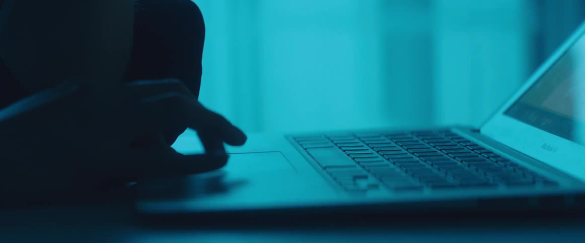 A person is browsing on their laptop