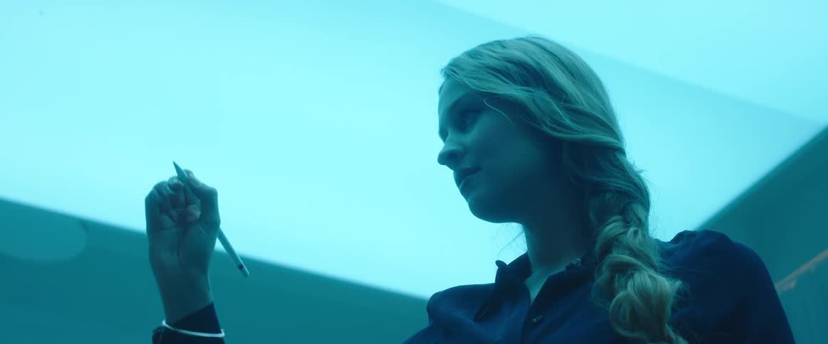 Woman drawing in the air with a stylus inside an office