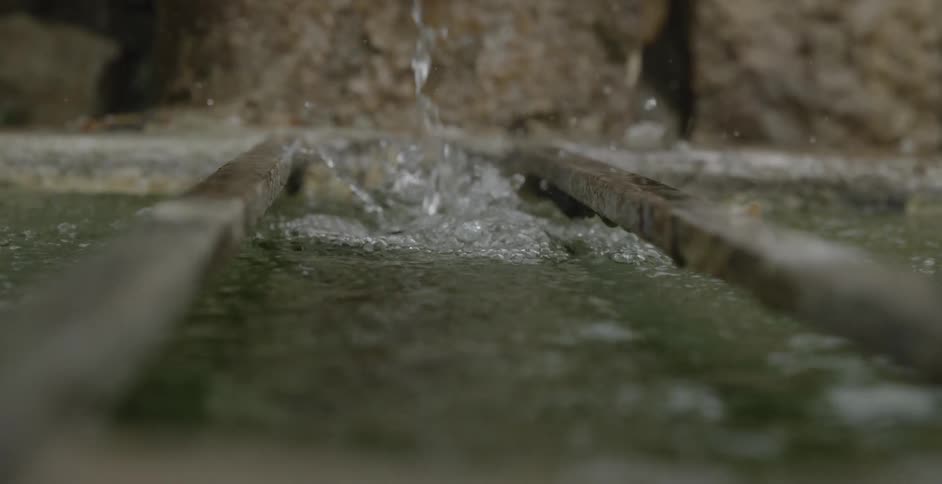 Water is dropping into an iron grate below