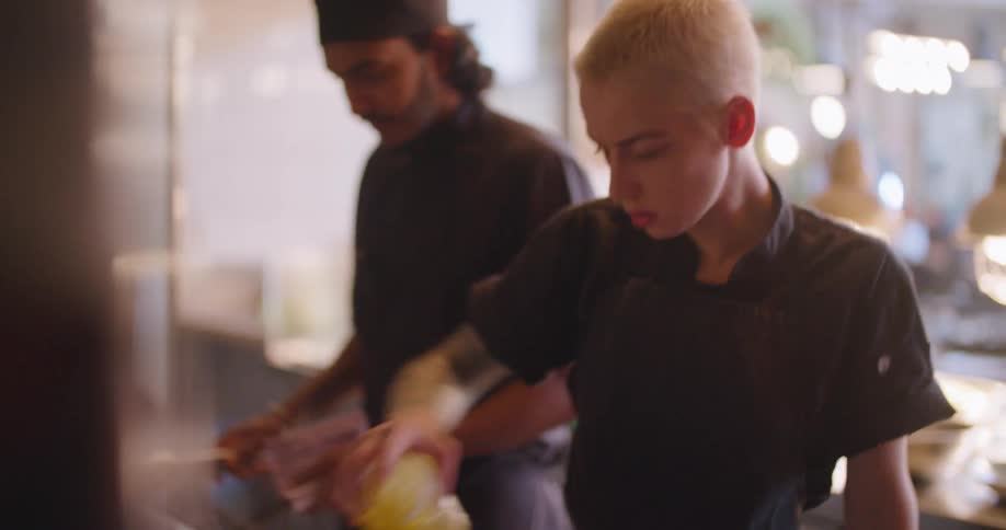 Two chefs cooking in a restaurant kitchen