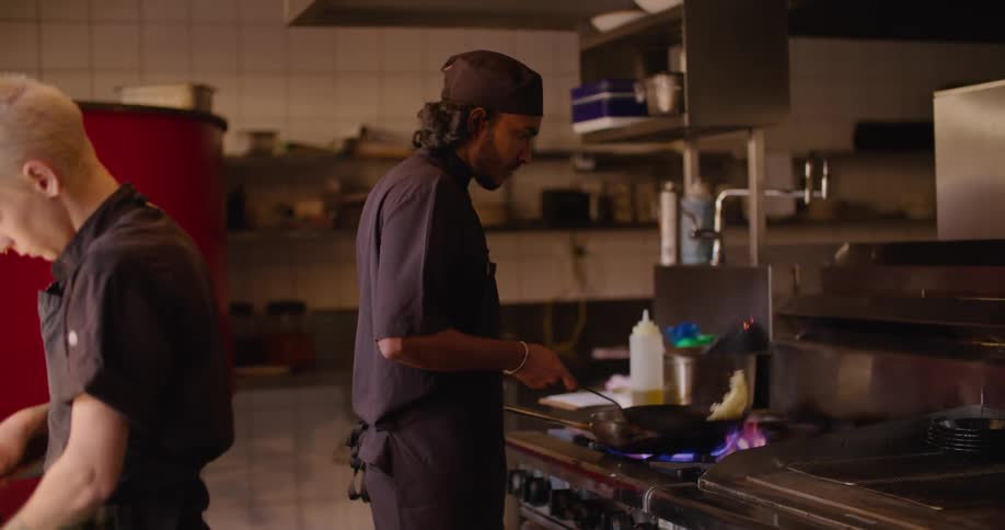 Two chefs are cooking in the kitchen