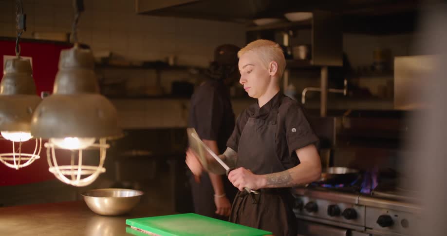 The chef is sharpening her knife