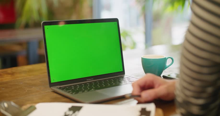 Laptop with green replaceable screen over a desk in the office