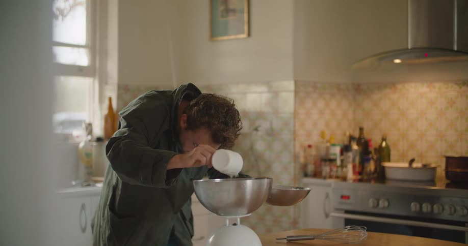 A man cooking food in a kitchen