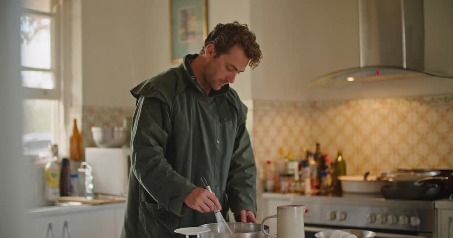 A man cooking food in a kitchen
