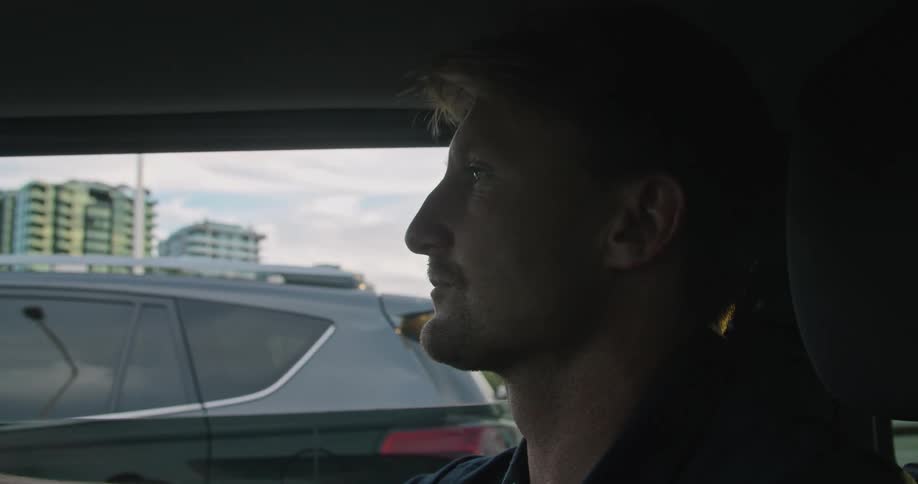 A man driving a car down a road