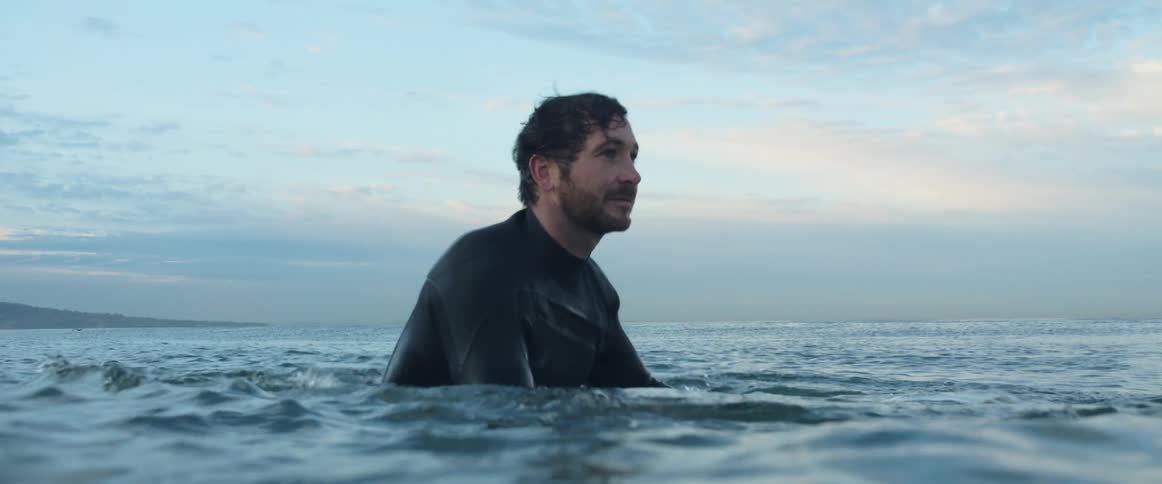 A man paddling in the ocean