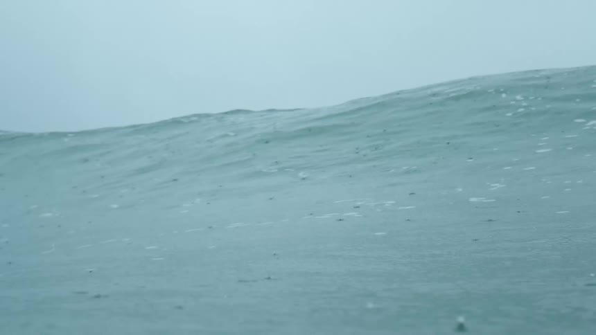 Wave on rough water moves overhead and an underwater view