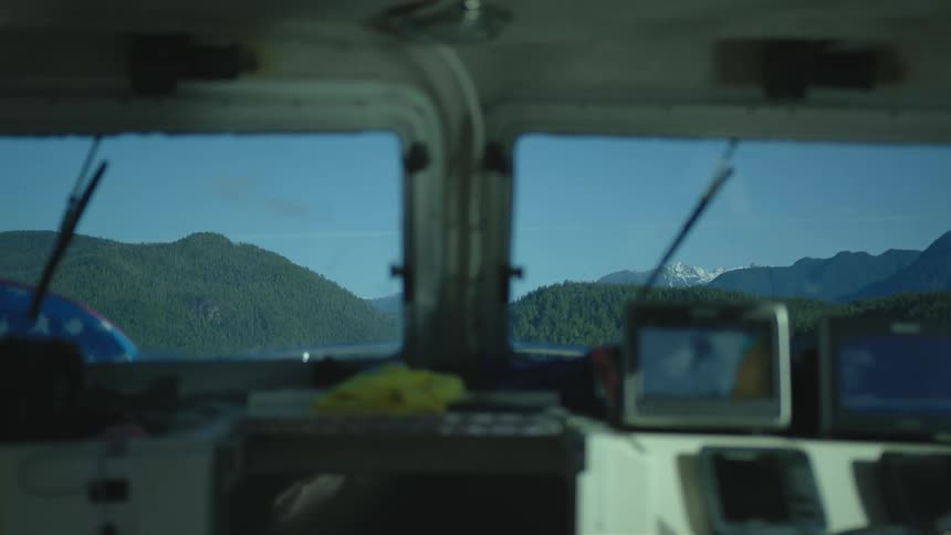 Cabin of a boat navigating on a lake in the mountains