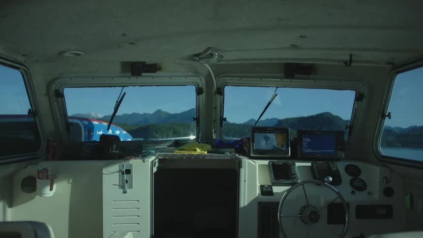 The boat cabin is empty as it sits in the lake