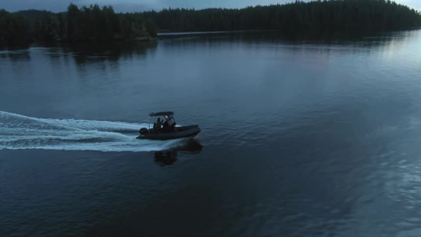 A boat is racing across the lake