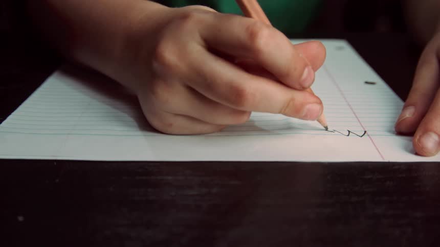 A person writes on a piece of paper and the pencil breaks