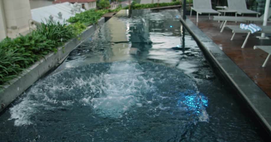A man diving into a pool and swimming