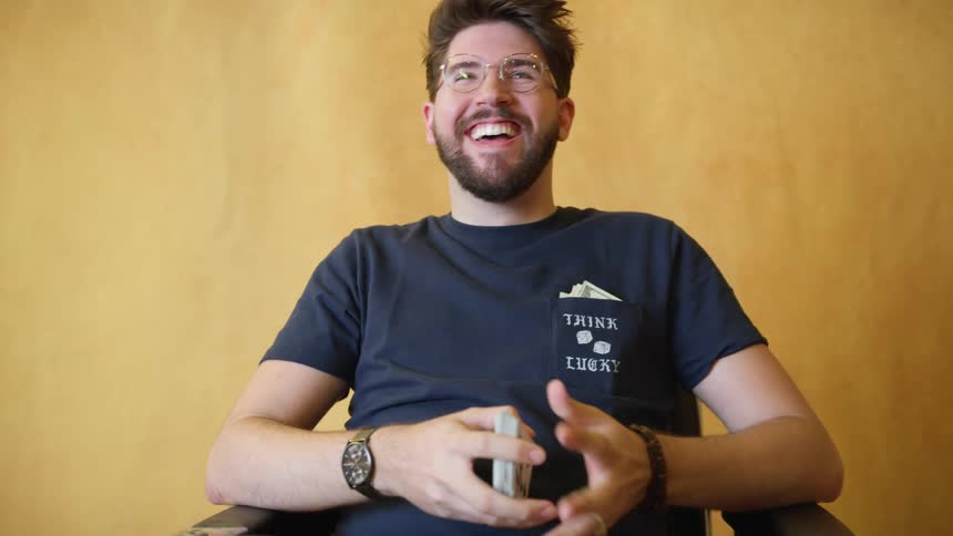 Man sitting on a chair lauging and talking