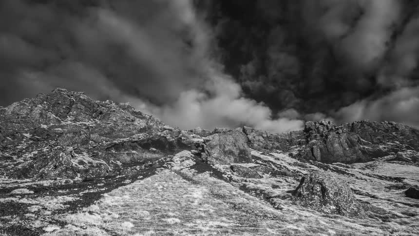 Clouds moving quickly over icy mountains