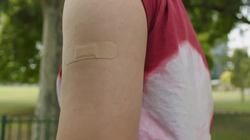 Close up of a womans arm with a bandage on it