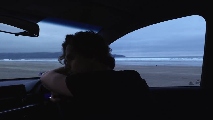 A man resting in a car