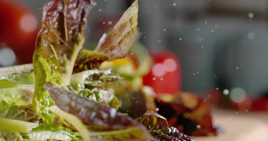 A knife comes down cutting lettuce