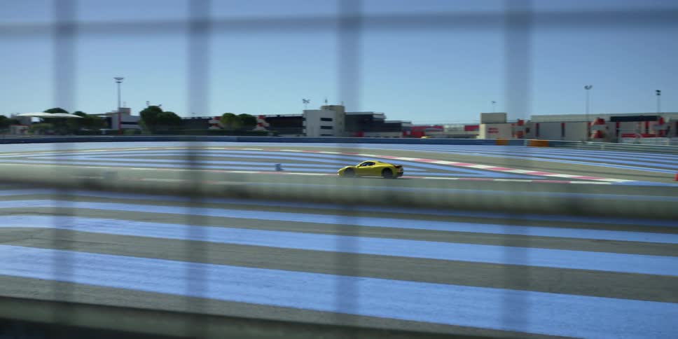 A sports car travels the lane on a race track by themself