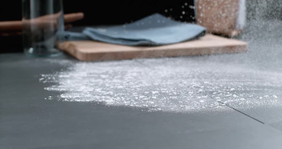 Flour is thrown on a counter for a photo shoot