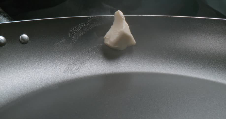 Piece of butter sliding over a hot pan