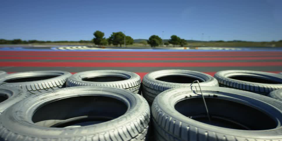 Tires piled up at the side of a racetrack