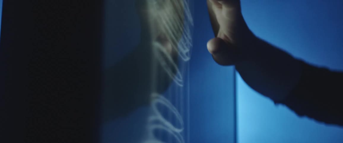 Two coworkers looking at imagery on a computer screen in a dark room