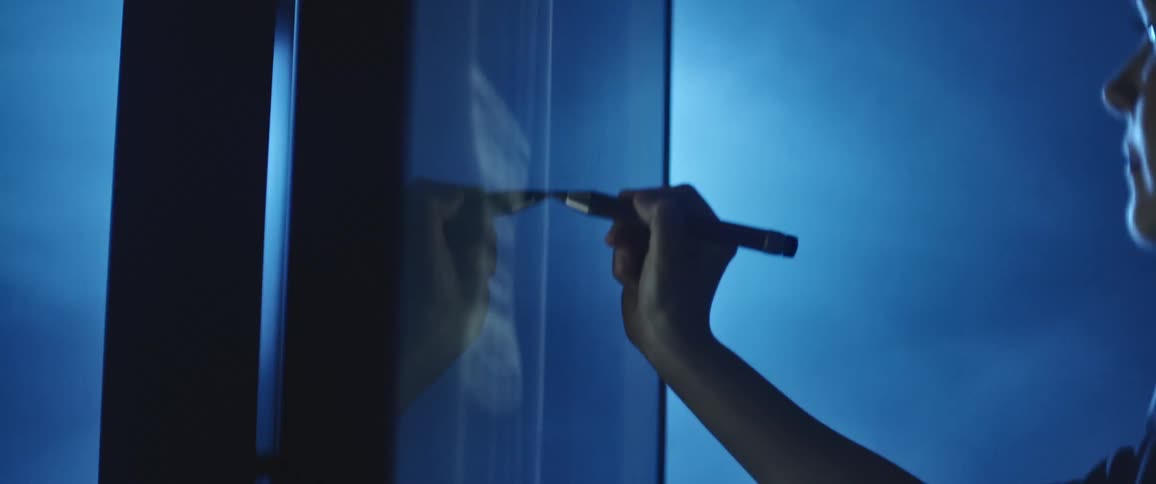 Woman draws on a large monitor with a digital pen