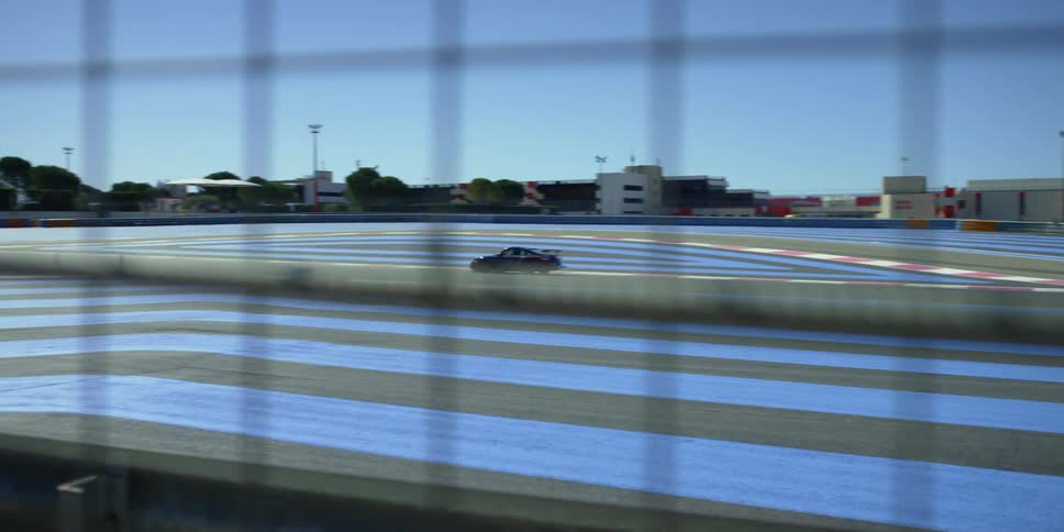 A sports car drives on a sports track by itself