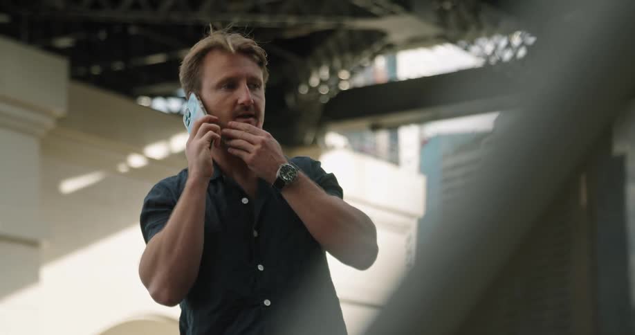A man outside talks on his cell phonen