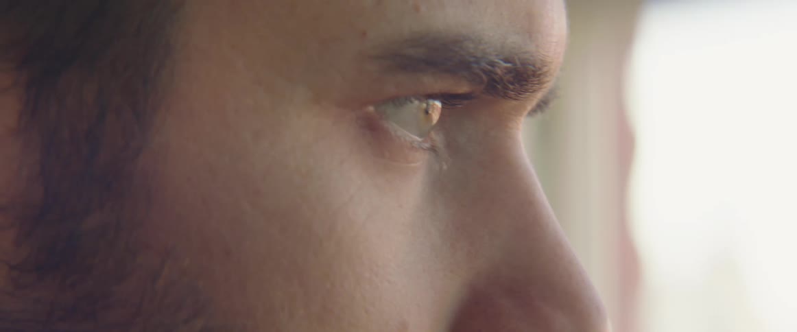A young man looks out a window