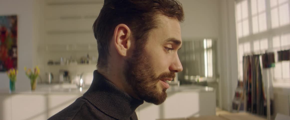 A man is talking in his home