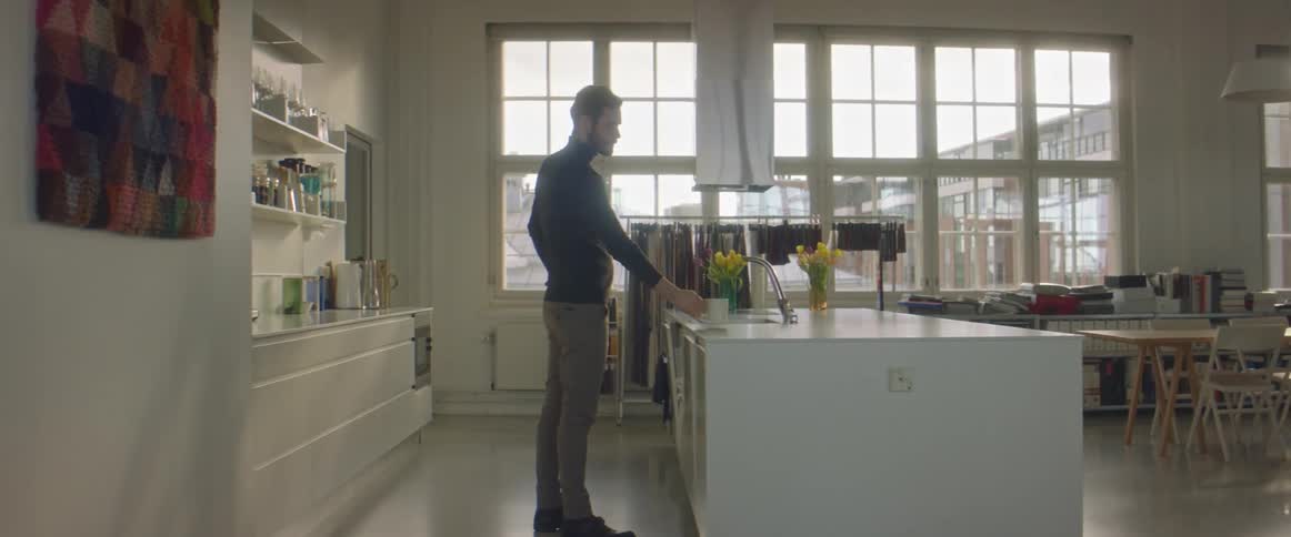 Bearded young man drinking a hot beverage at home